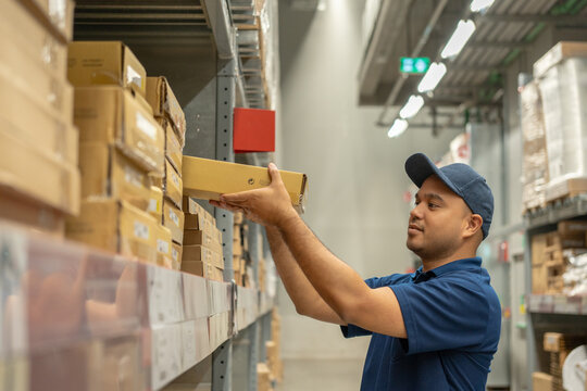 Closeup hands picking up products box paper on shelf. Customers picking up items on shelves. Warehouse worker check stock inspecting in logistic factory.