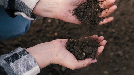 woman farmer pours environmentally friendly soil hands, touching soil field with fingers, farmer organic gardening engineer, growing seeds, growing vegetables field farm, business, hands soil close-up