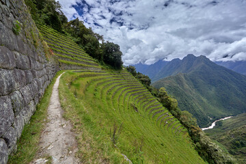 Naklejka premium Wiñay Wayna is situated on the Inca Trail, which is the famous hiking route that leads to Machu Picchu. It is located approximately 4 kilometers (2.5 miles) from Machu Picchu.