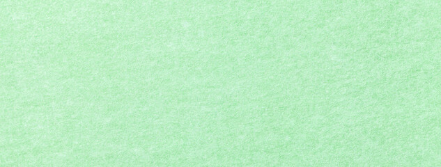 Texture light green color background from felt textile material, macro. Structure vintage pastel mint fabric cloth