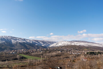 Anatolian Village Scene with Snow-Capped Mountains