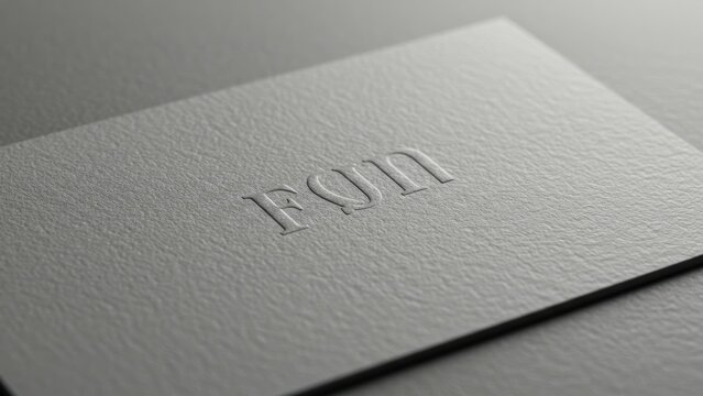 Embossed gray business card with textured surface features elegant typography and minimalist design Suitable for branding and professional identity