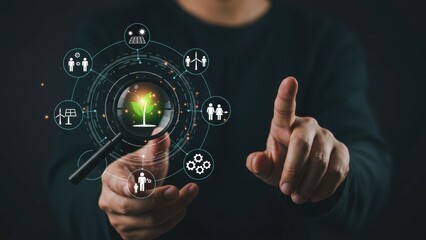 Young Asian man using magnifying glass on digital icons to symbolize sustainability and growth Concept reflects innovation and technology themes