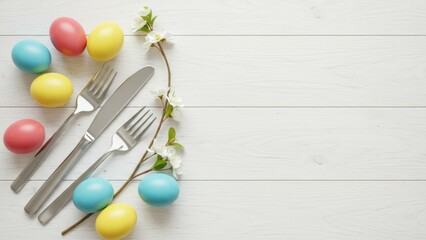 Obraz premium Colorful Easter eggs and decorative forks arranged on rustic white wooden table Spring theme, Easter celebration, festive atmosphere