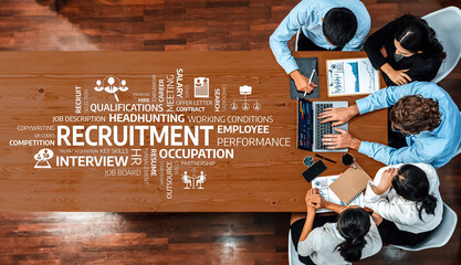 A diverse team collaborates around a wooden table, focusing on recruitment strategies, performance metrics, and qualifications to enhance workforce engagement and efficiency. Amity