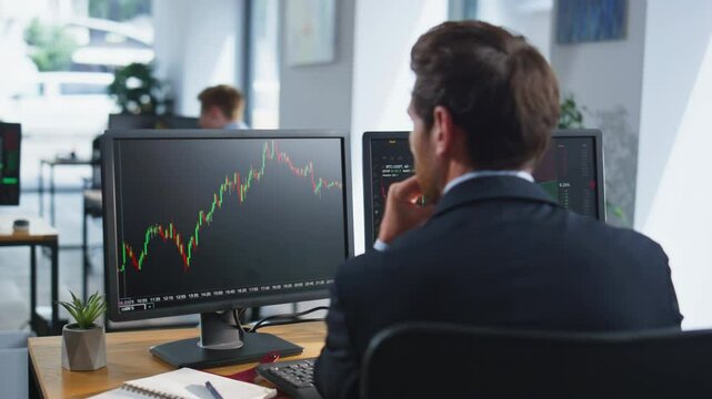 Stock trader looking monitors analyzing currency market charts in office closeup