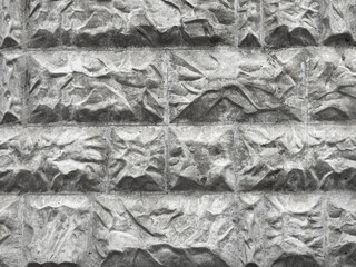 Stone cladding wall made of facade of the house. Artificial stone brick wall textured. Pattern of bricks for background. Bumpy, uneven tiles for outdoor decoration. Industrial theme