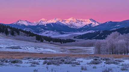Majestic sunrise over snow-covered mountains with a serene valley in the foreground and frosty trees