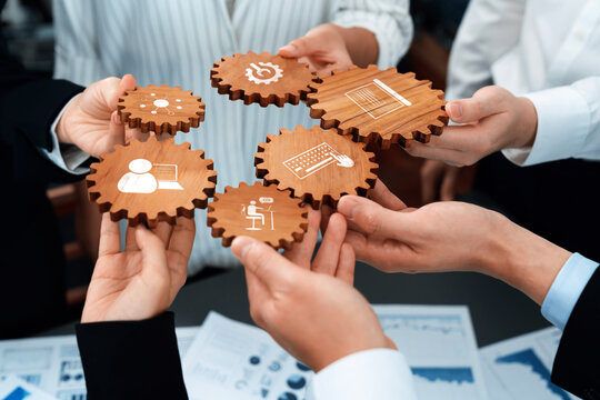Collaborative Business Teamwork with Wooden Gears Representing Management, Strategy, Productivity, and Technology in a Professional Setting. Amity