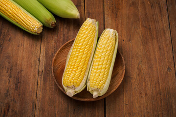 yellow sweet corn on wooden background