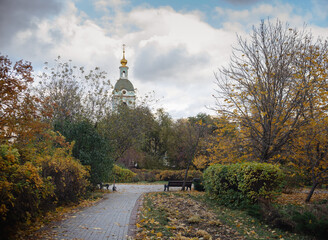 Green square near Yauzа River, view of the bell tower in Moscow, Russia