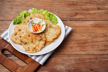 Bakwan sayur is a typical Indonesian vegetable fritter. The ingredients are made from wheat flour mixed with cabbage, carrots, and bean sprouts. Indonesian street food.