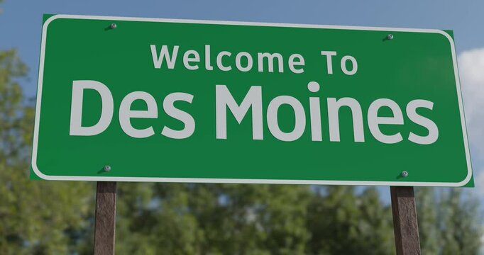 Driving By A Welcome To Des Moines, Iowa Green Road Sign Against a Blue Sky and Clouds - United States Capital Series.