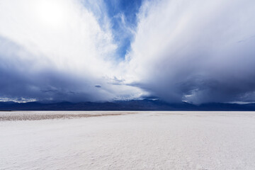 Fototapeta premium Badwater Basin with winter storm clouds at Death Valley National Park in California. Badwater dry lake is the lowest elevation in the United States.