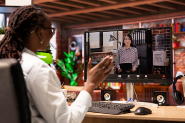 Woman doing videocall interview with human resources representative, waving hand, applying for company position. Candidate at home doing teleconference meeting with HR employer, saluting her