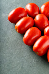 Seasonal Italian Tomatoes on Green Surface for Healthy Vegan and Vegetarian Cooking, Copy Space