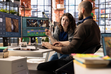 Creative couple working together on video editing software for movie making, using AI powered...