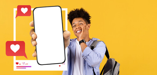 An influencer holds out a smartphone displaying an empty screen while smiling enthusiastically.