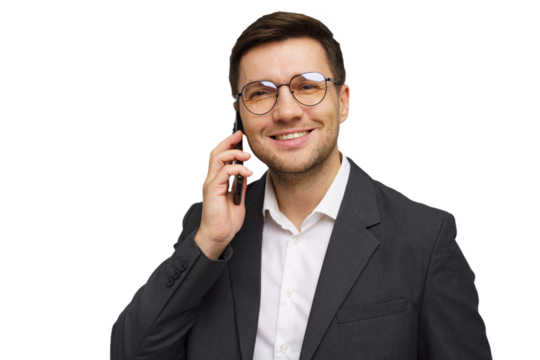 Business professional smiling while talking on mobile phone in a studio setting during the day
