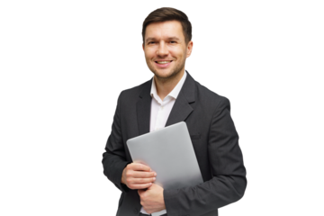 Professional man in a suit holding a laptop while smiling confidently in a studio setting