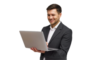 Businessman smiling while holding a laptop in a professional setting, focusing on work during the day