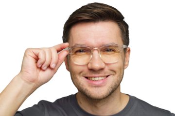 Young man adjusting clear glasses while smiling, showcasing friendly demeanor in casual attire