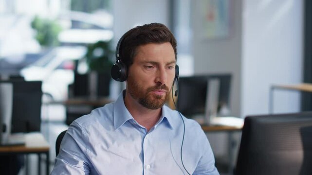 Online manager talking headphones providing customer support in office closeup.
