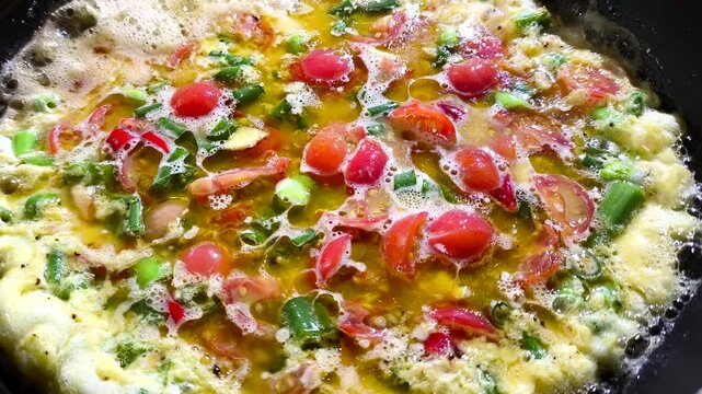 Frying  omelet   in pan, in door  Chiangmai  Thailand.
