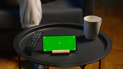 African american casual guy relaxing on the couch next to isolated screen, feeling pleased with working from home at his cool apartment. Young adult laying on the sofa, remote job. Camera A.