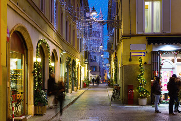 Naklejka premium View on the New Year's illuminated streets of Parma at evening, Italy
