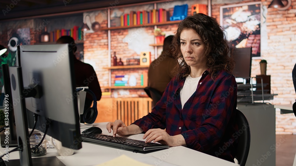 Poster woman using pc in startup office to design and implementing algorithms enabling machine learning. te