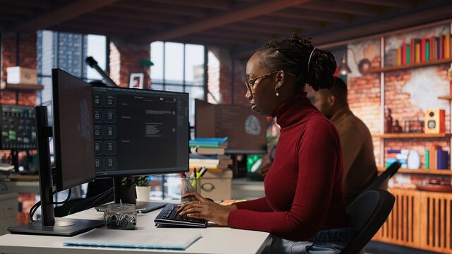 Software development agency expert solving tasks with AI LLM chatbot answering prompts. Startup company employee using computer to interact with large language model program, camera A
