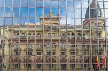 Obraz premium Reflection of buildings on Gran Via in Madrid, Spain