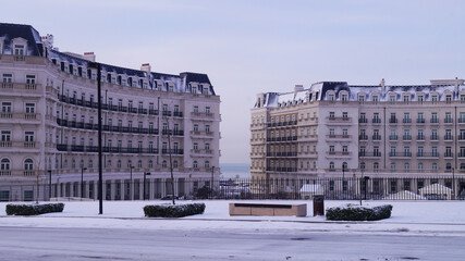 view of winter empty street with english style houses