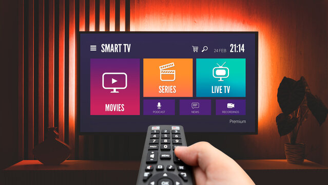 Man watching TV, remote control in hand