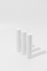 Three White Cylinders on White Background