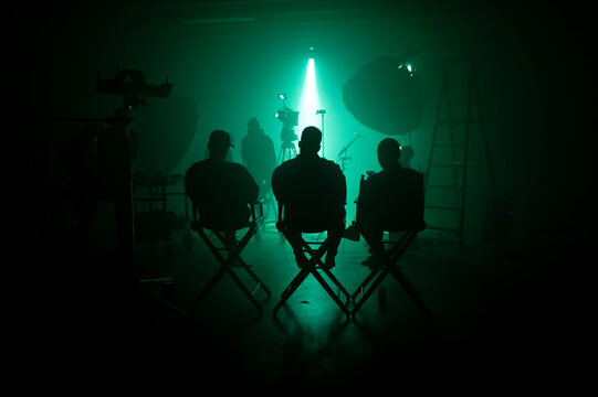 silhouettes of people on a haze filled film set