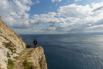 Hiking path with tourist at beautiful rocky landscape of mediterranean coastline at cape Maleas, Laconia, Peloponnese, Greece