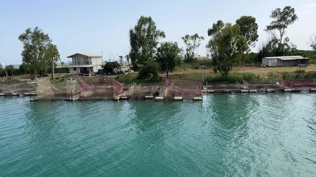 Fish Farming Nets Submerged in Manavgat River, Side, Turkey &ndash; Aquaculture in Flowing Water