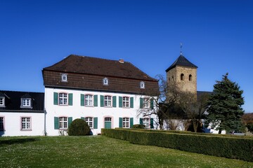Fototapeta premium LVR Office for the Preservation of Monuments in the Nideggen Field Office in Wollersheim in the background the historic listed old church