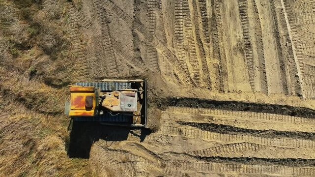 construction work of bulldozer during road construction. Large bulldozers level the sandy base. Epic footage of large construction equipment working. drone view of road construction. Overhead shot 