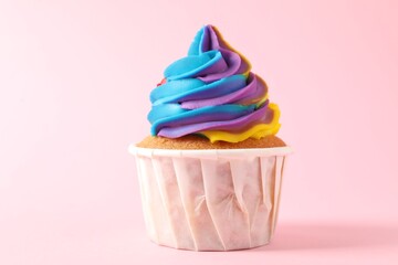 One delicious cupcake with colorful cream on pink background, closeup