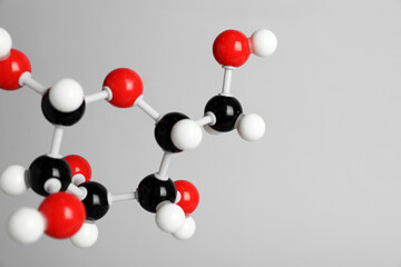 Molecule of glucose on light grey background, closeup and space for text. Chemical model