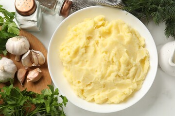 Delicious mashed potato served on white table, flat lay