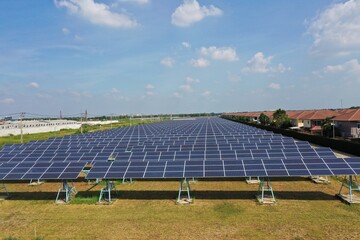 Solar Farm (solar cell) on sunny day background with electric power generation in agricultural area . Renewable green alternative energy. Power plant.Solar photovoltaic rows array ground mount system