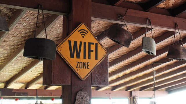ellow board hanging on the wall with the inscription "WIFI ZONE"
