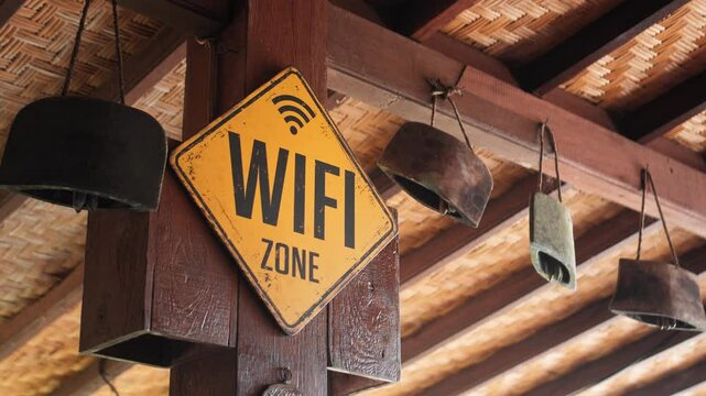 ellow board hanging on the wall with the inscription "WIFI ZONE"