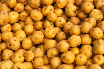 Many organic yellow potatoes in the Colombian peasant market square - Solanum phureja