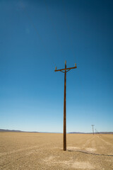 Portrait View of Telephone Pole in Desert.