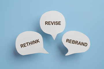 For business management branding concept of rethink revise and rebrand text on real paper cut speech bubble
